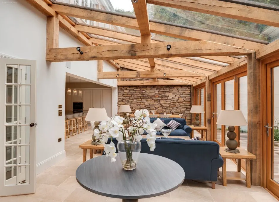 Modern room with architectural ceiling beam elements.