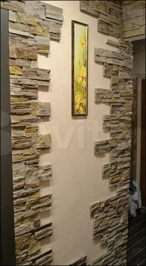 Modern entrance hall with decorative stone wall panels.