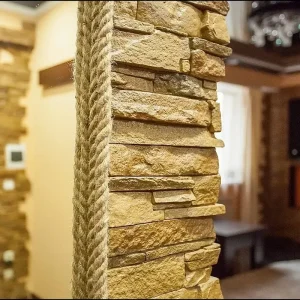 Decorative stone cladding in a bright corridor interior.