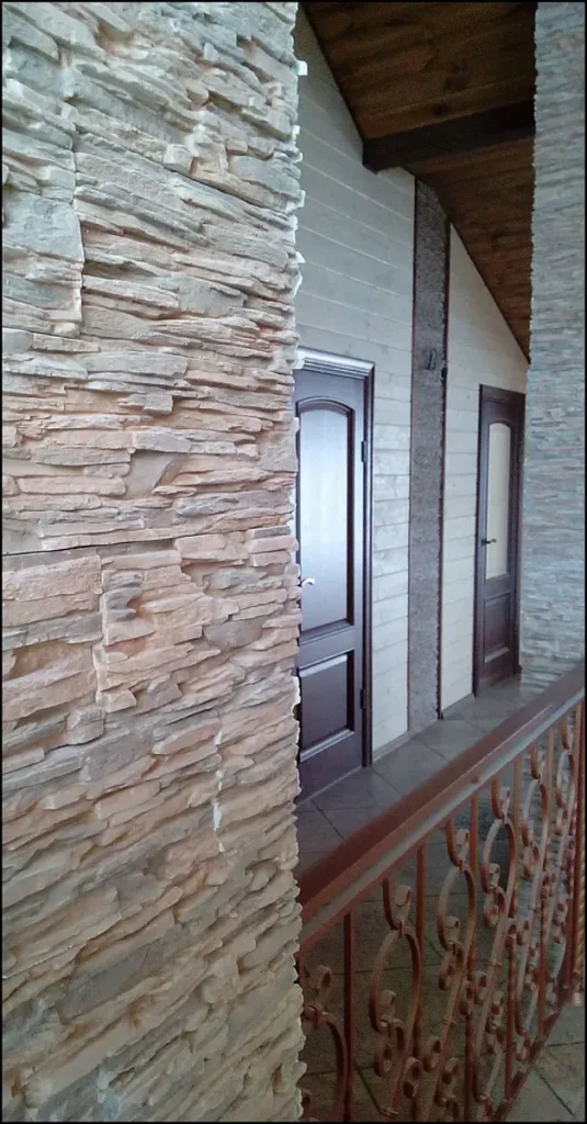 Decorative stone wall in a minimalist corridor interior.