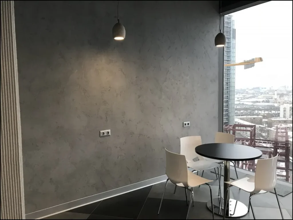 Contemporary living space with a concrete-look wall.