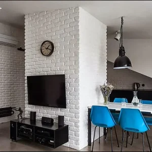 Minimalist bedroom featuring gypsum brick accent wall.