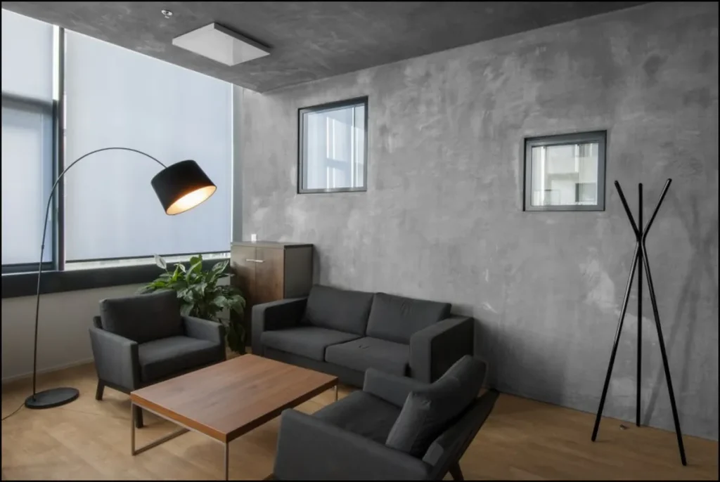 Contemporary room featuring a concrete-look decorative wall.