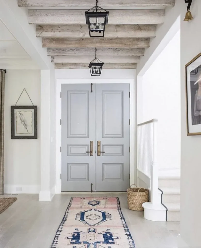 Rough-hewn wooden beams overhead in a loft-style room interior.
