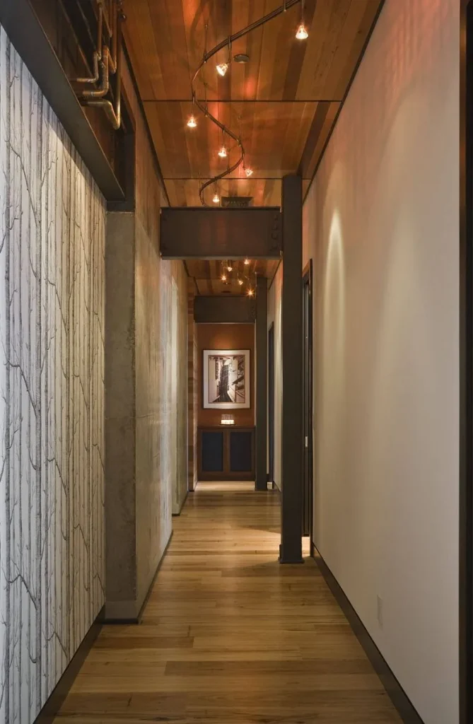 High ceiling with heavy wooden beams in an open-plan loft room.