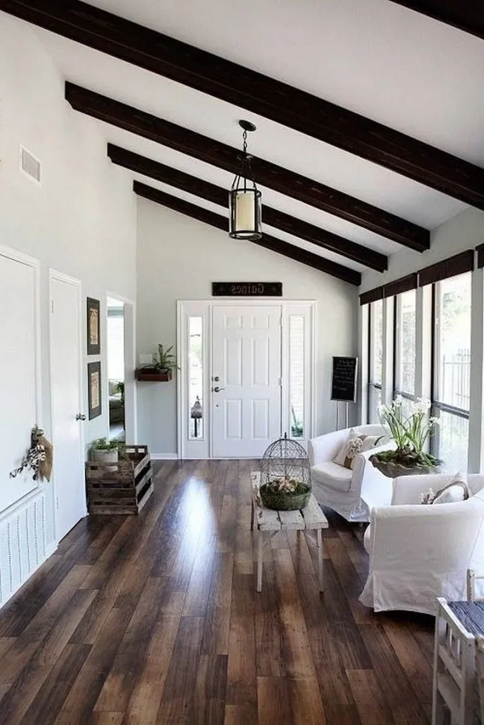Industrial ceiling layout with exposed black metal beams and ductwork.