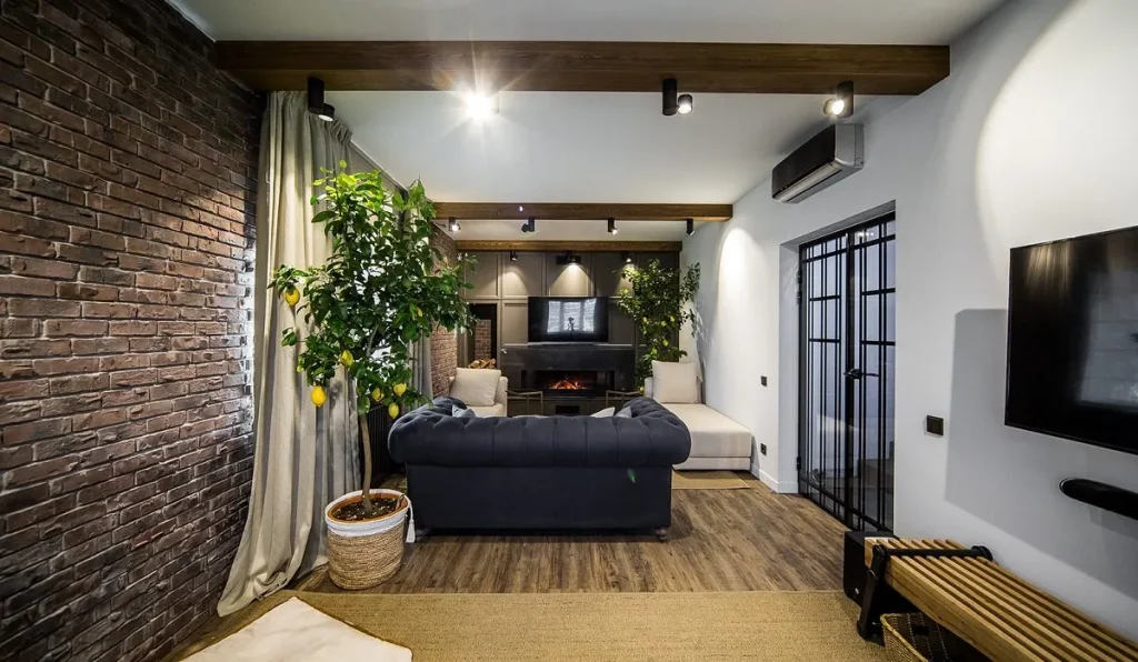 Open-plan living room featuring crisscrossed wooden ceiling beams.
