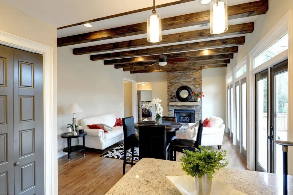 Dining room area with natural wood beams spanning the ceiling.