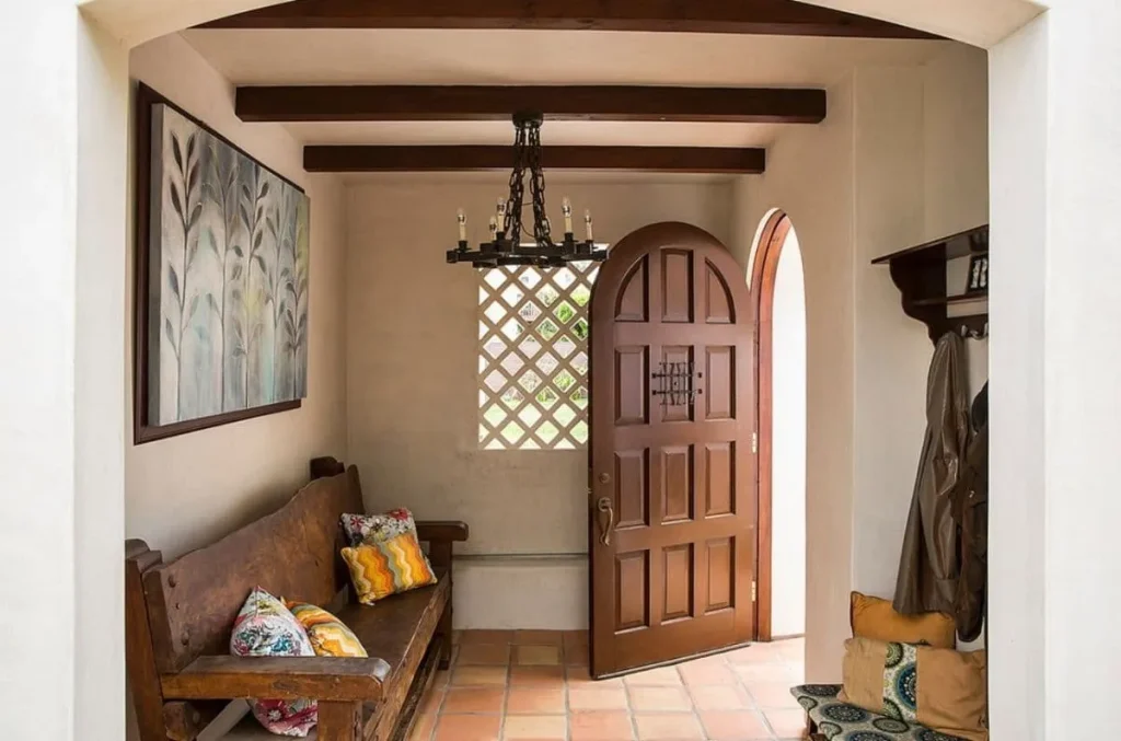Loft-style room with dark wooden beams and hanging pendant lights.