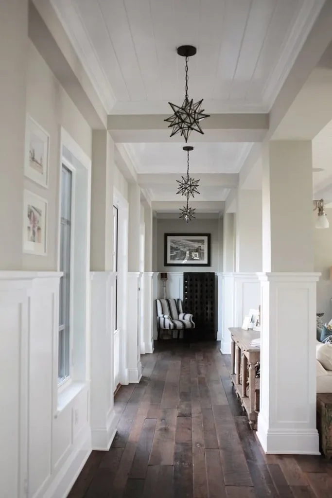 Contemporary room interior with light wood ceiling beams and track lighting.