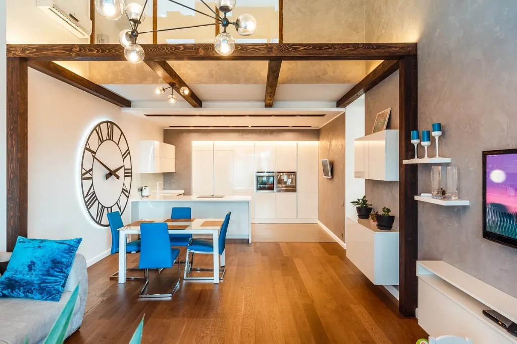 White painted wooden beams on a ceiling in a contemporary room interior.