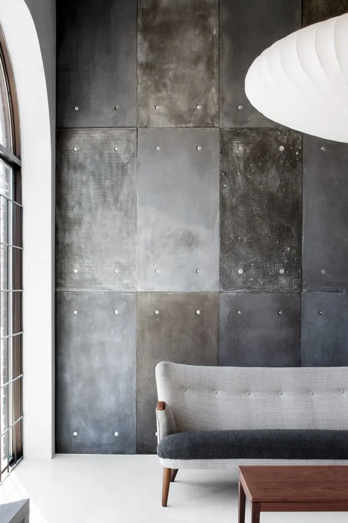 Modern living room with a textured concrete wall.