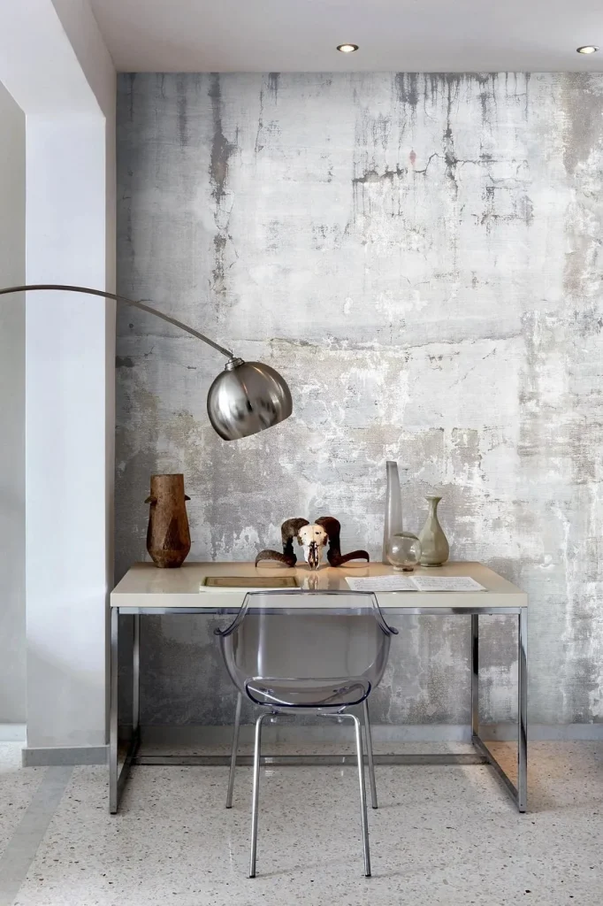 Textured concrete accent wall behind a sofa in a contemporary space.