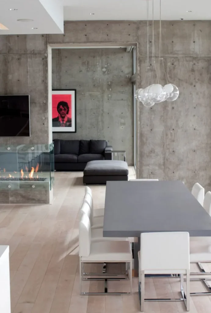 Exposed concrete feature wall in a spacious loft-style living room.