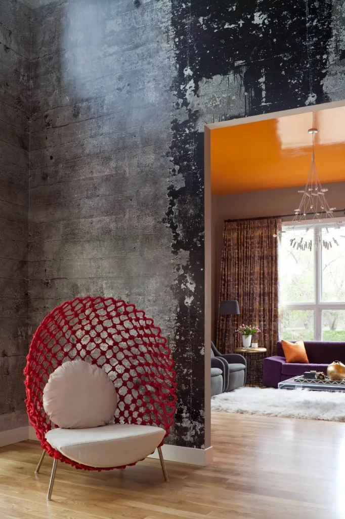 Living room interior combining raw concrete walls with soft textile decor.