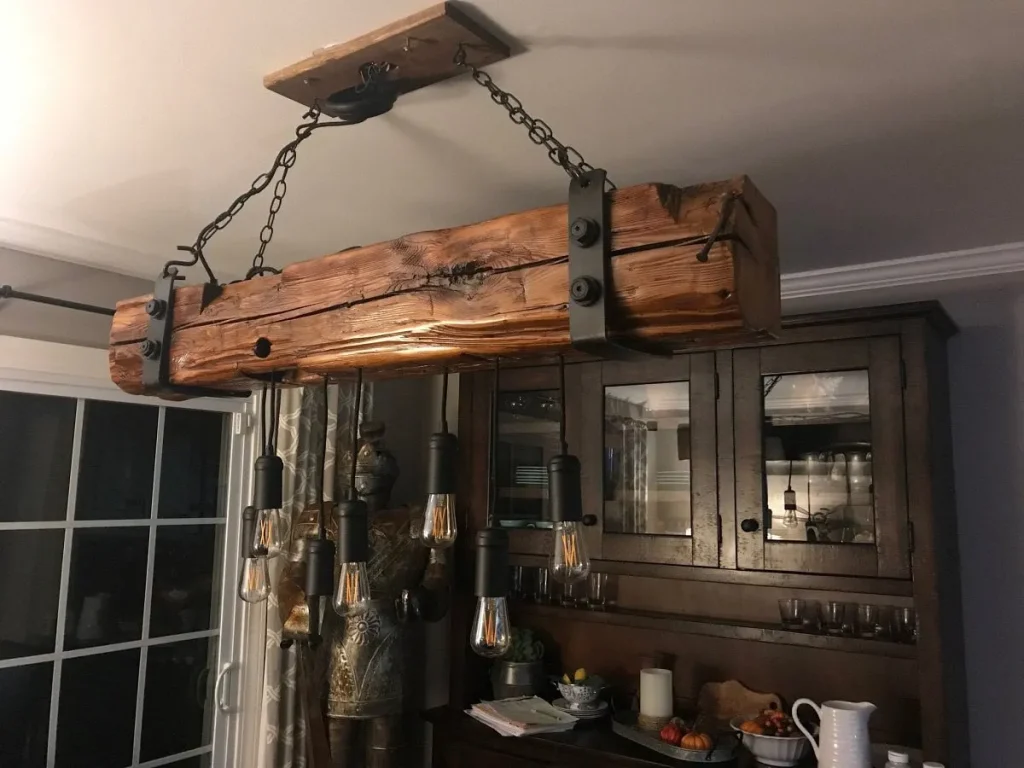 Multi-bulb industrial spider chandelier with hanging black cords.