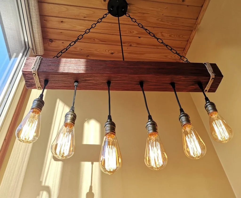Multi-arm industrial chandelier with exposed filament bulbs.
