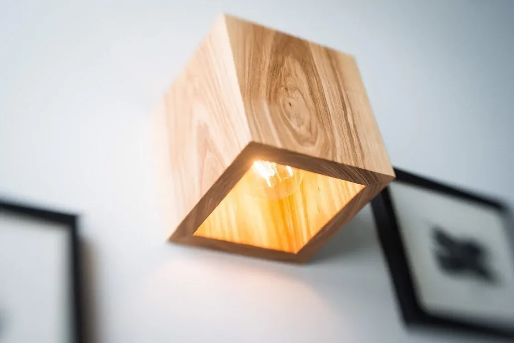 Linear industrial pendant light fixture with metal mesh paneling.