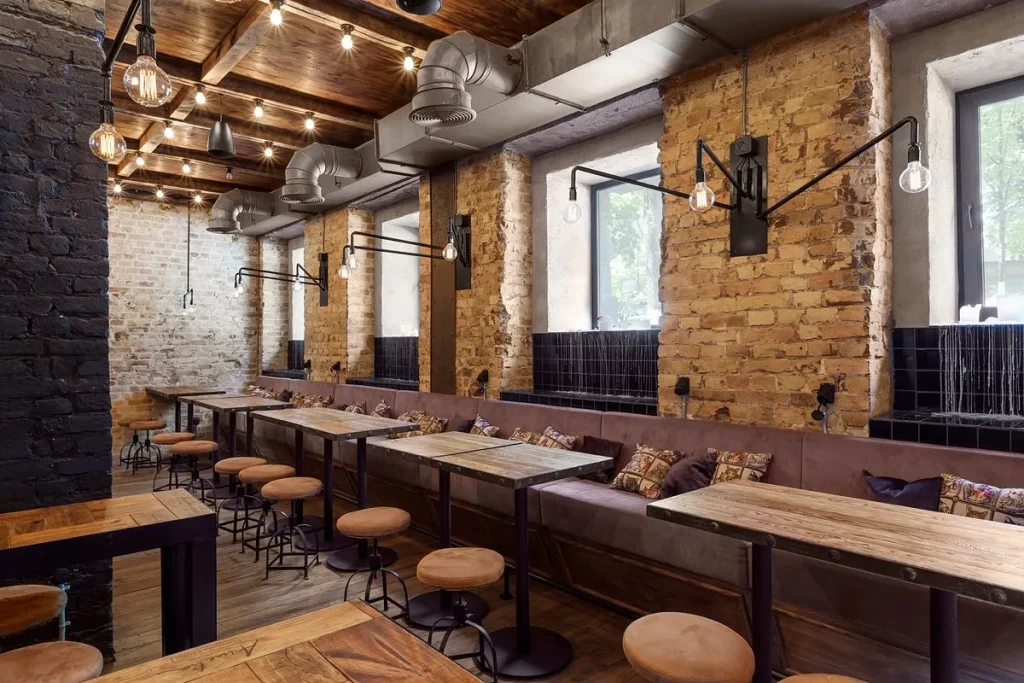 Cafe counter made of reclaimed wood and black metal in a loft setting.