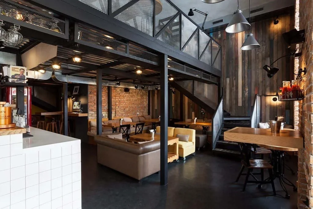 Spacious loft cafe with polished concrete floors and wooden seating.