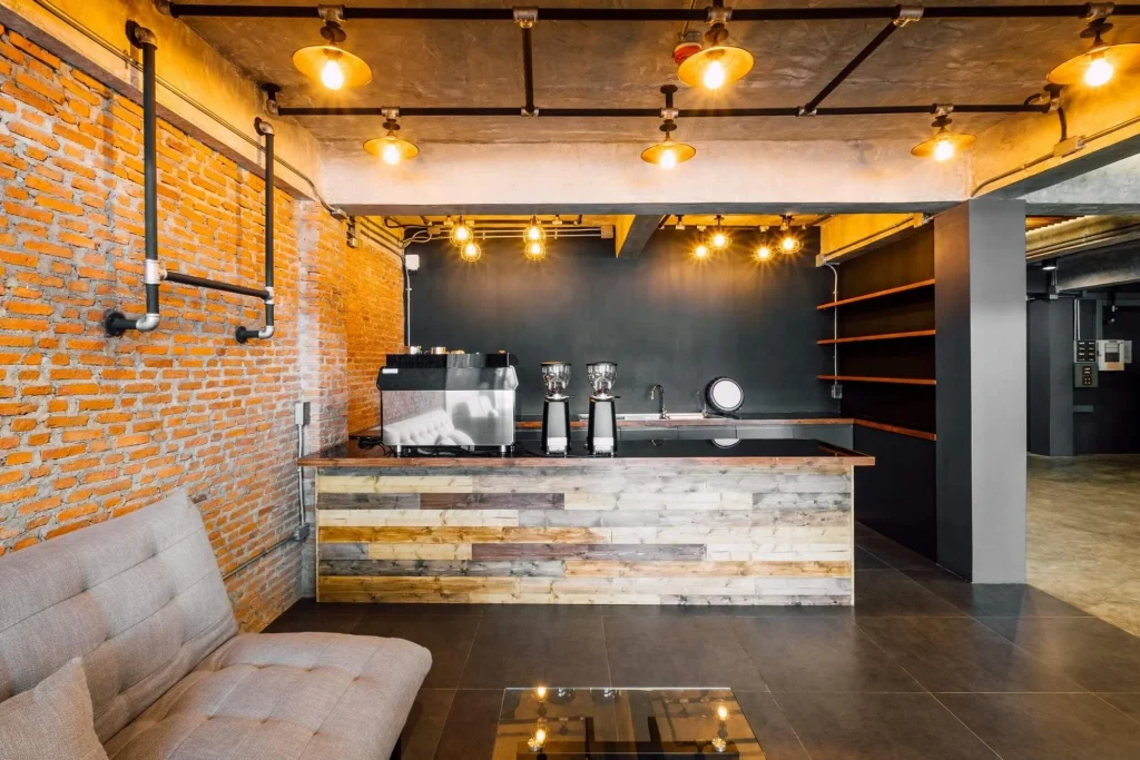 Bright loft cafe space with tall industrial windows and natural light.