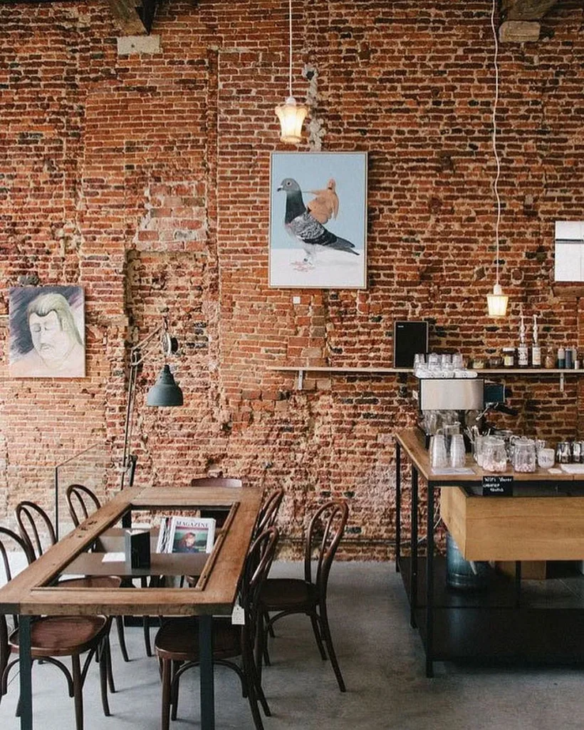Cafe seating arrangement with metal frame chairs and small round tables.