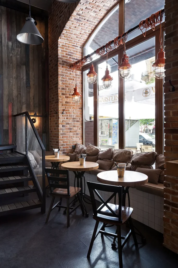 Comfortable lounge area in a loft-style cafe with leather armchairs.
