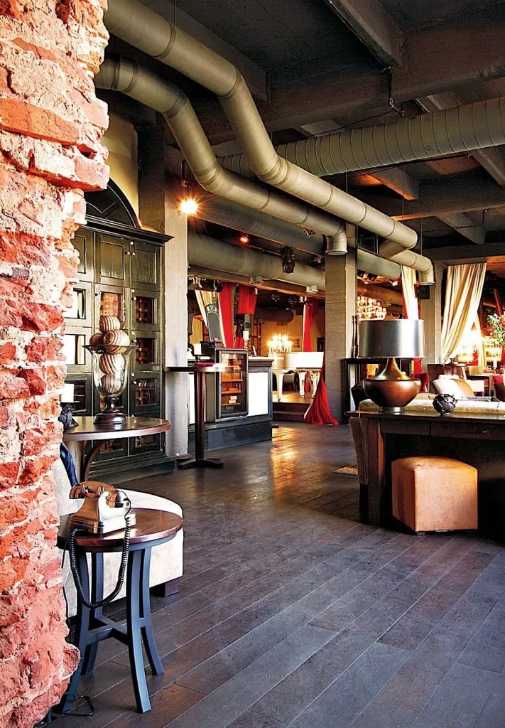 Industrial coffee shop counter with black metal finishes and warm illumination.