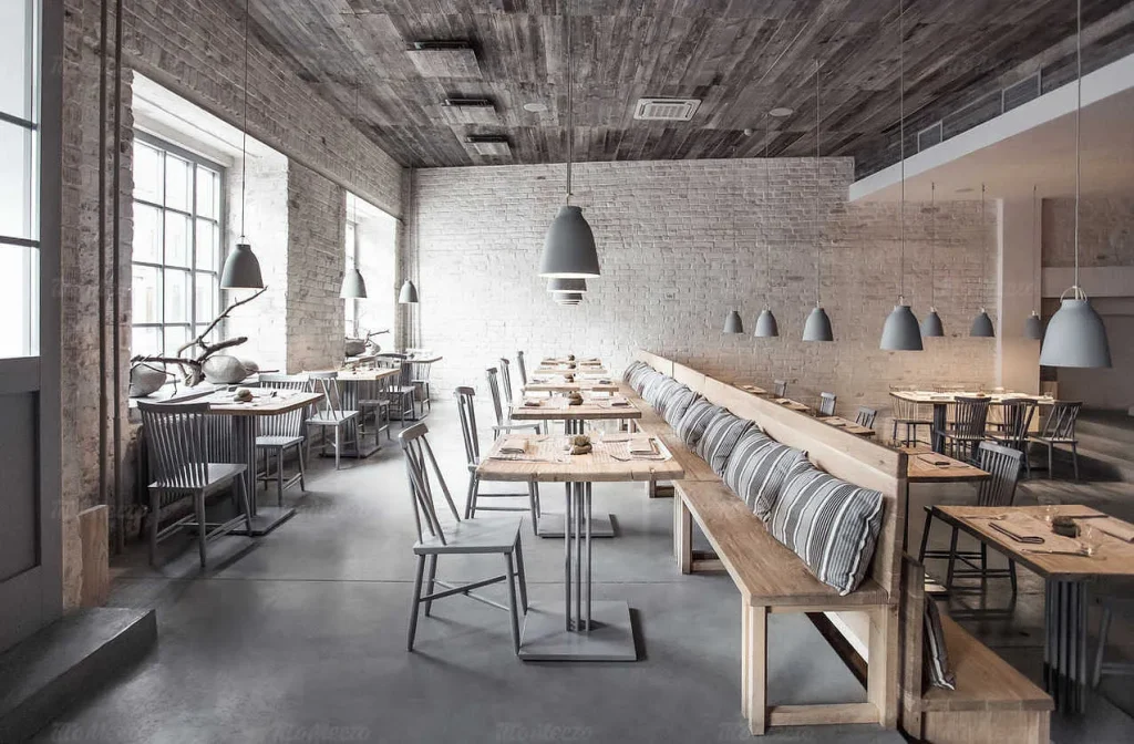 Cafe interior with a mix of raw timber, black metal, and exposed brickwork.