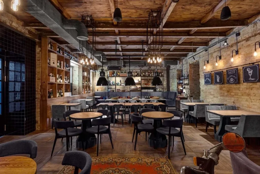 Spacious loft cafe with polished concrete floors and wooden seating.