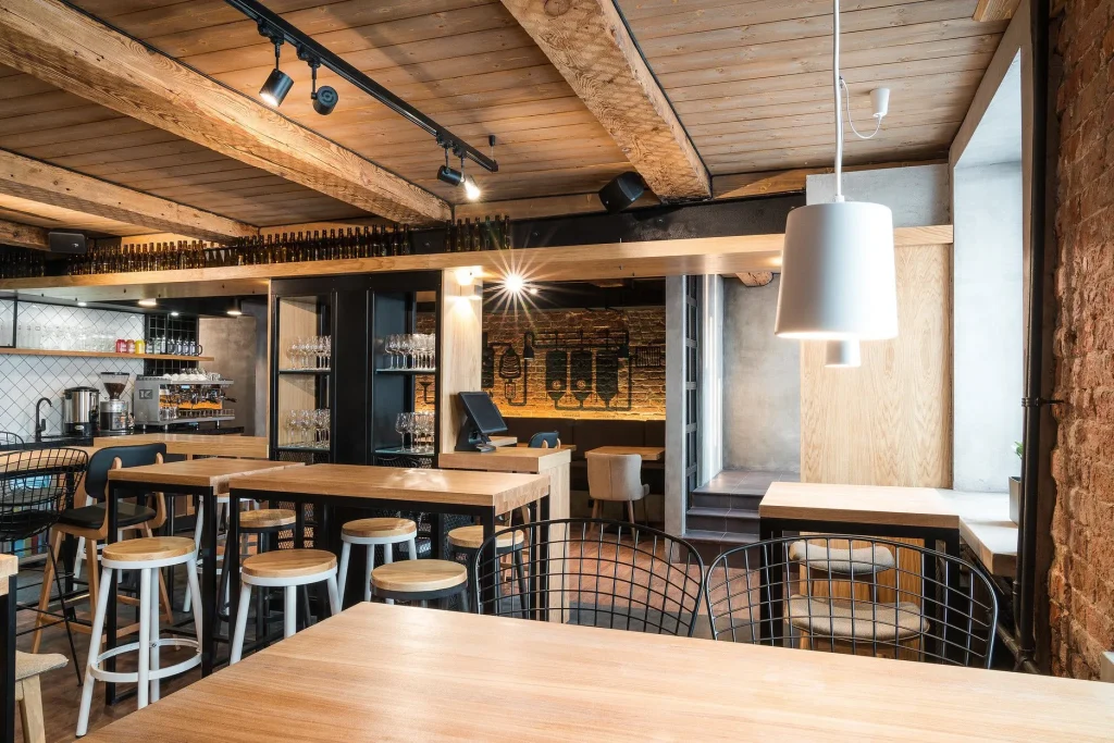Cafe dining space featuring a combination of brick walls and metal furniture.