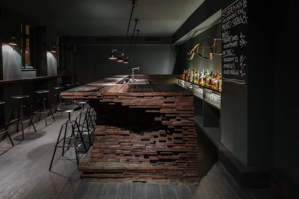 Loft-style coffee shop interior featuring a long communal wooden table.