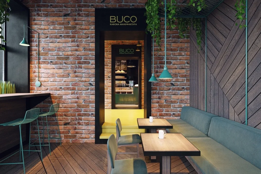 Modern loft-style cafe featuring hanging metal pendant lights and bar seating.